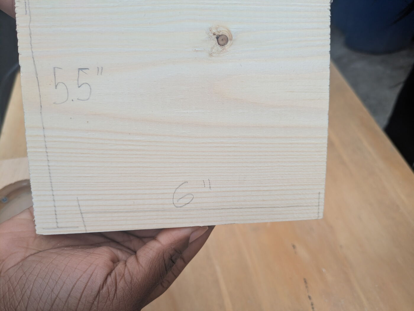 Close-up of a pine piece marked 5.5 inches by 6 inches.